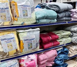 Shelf display of household textiles in multiple colors